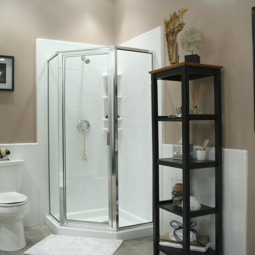 This corner shower remodel idea features a neo-angle corner shower base, white shower base and simulated tile pattern for the wall surround. corner shower, shower remodel, shower system, neo-angle shower